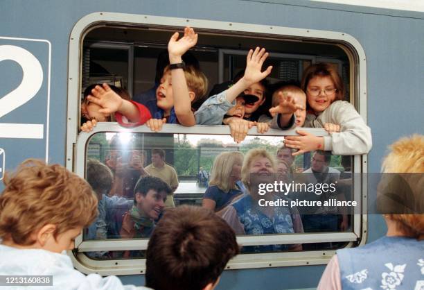 Fröhlich winkend verabschieden sich Jungen und Mädchen aus dem Berliner Schülerladen "Wilde 14" am 16.7.1999 auf dem Bahnhof Berlin-Zoo von ihren...