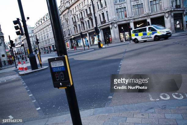 Police van drives across a near-deserted Oxford Circus in London, England, on May 15, 2020. Nearly eight full weeks have now passed since British...