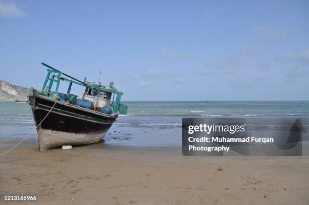 a boat on gawadar beach - balochistan stock pictures, royalty-free photos & images