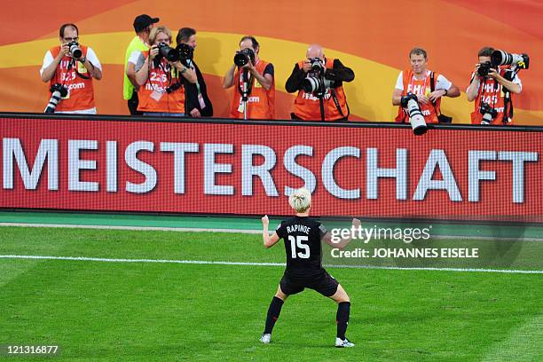 S midfielder Megan Rapinoe celebrates in front of photographers after the quarter-final match of the FIFA women's football World Cup Brazil vs USA on...