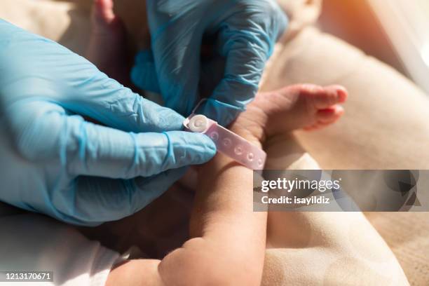 a baby's foot in mother hands - tickling feet stock pictures, royalty-free photos & images