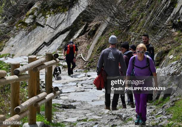 Tourists walk near the Montenvers train site at the 'Mer de glace' glacier near Chamonix Mont-Blanc, eastern France, on May 16 on the first weekend...