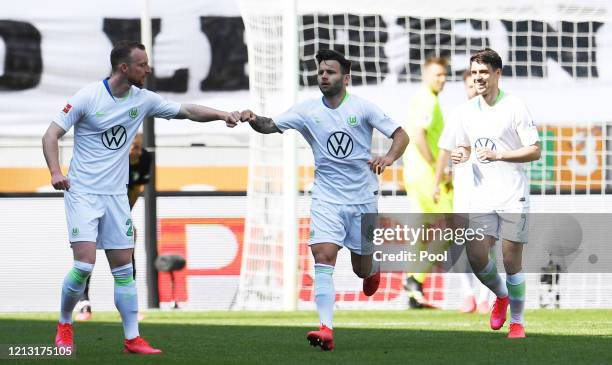 Renato Steffen of VfL Wolfsburg celebrates with teammate Maximilian Arnold after scoring their team's first goal during the Bundesliga match between...