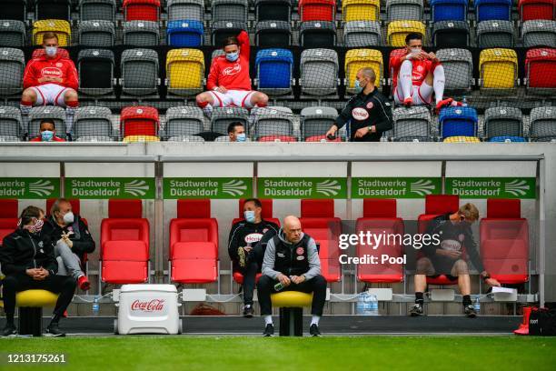 Fortuna Duesseldorf's head coach Uwe Roesler sits on the team bench on the sideline during the Bundesliga match between Fortuna Duesseldorf and SC...