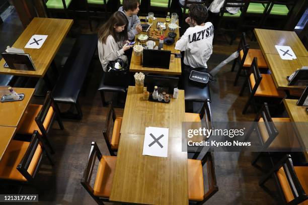 Deep-fried skewered meat restaurant in Osaka's Shinsekai commercial district is deserted on May 16 following the Osaka prefectural government's...