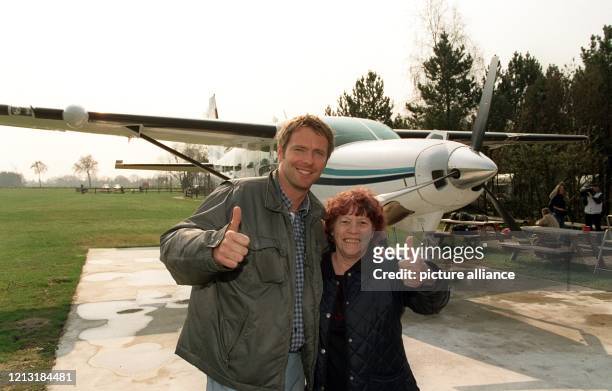 Moderator Jörg Pilawa und die 72 Jahre alte Anna Meert aus Belgien stehen am 20.4.2000 auf dem Flugplatz Hartenholm bei Bad Bramstedt vor dem...