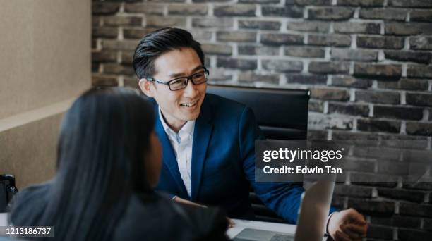 2 asian chinese white collar workers having discussion  using laptop - business meeting chinese stock pictures, royalty-free photos & images