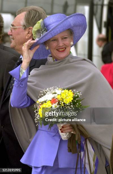 Die dänische Königin Margrethe II. Hält am 27.6.2000 während ihres Besuches auf der Weltausstellung Expo 2000 in Hannover lächelnd ihren Hut fest,...
