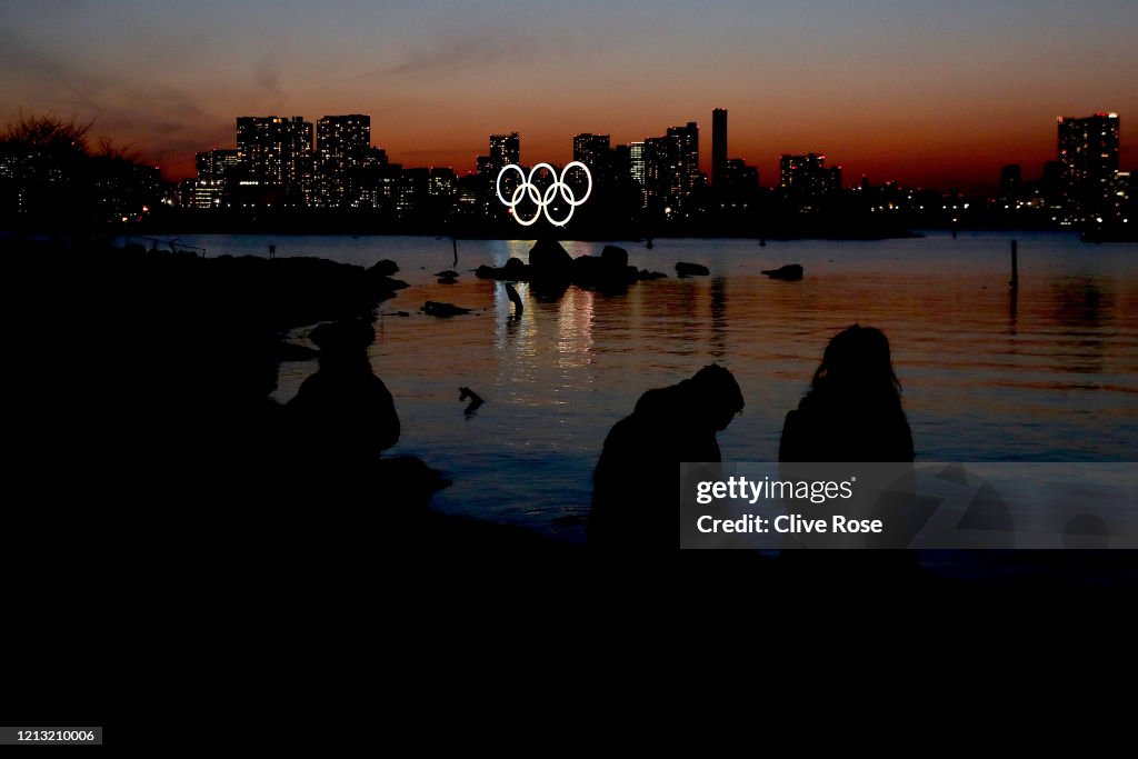 Olympic Rings Sunset A couple enjoy the sunset behind the Olympic rings installation at ...