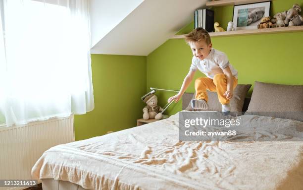 little boy jumping on the bed - ninja kid stock pictures, royalty-free photos & images