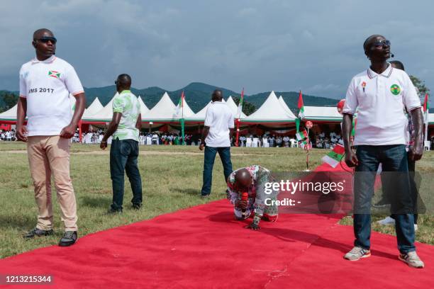 Burundis incumbent president Pierre Nkurunziza kneels on the ground as he prays during the last campaing of the ruling party, the National Council...