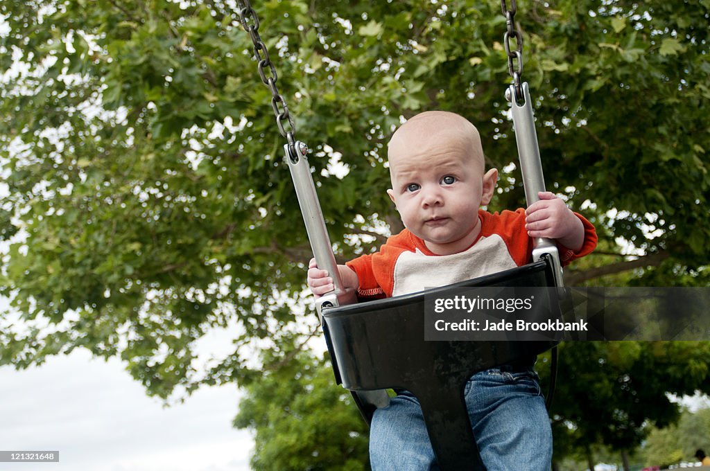 Infant in baby swing