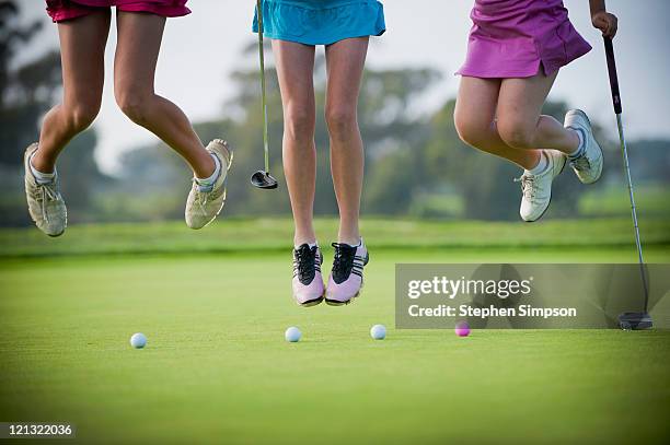 3 teen girls leaping on a putting green - golf girls stock pictures, royalty-free photos & images