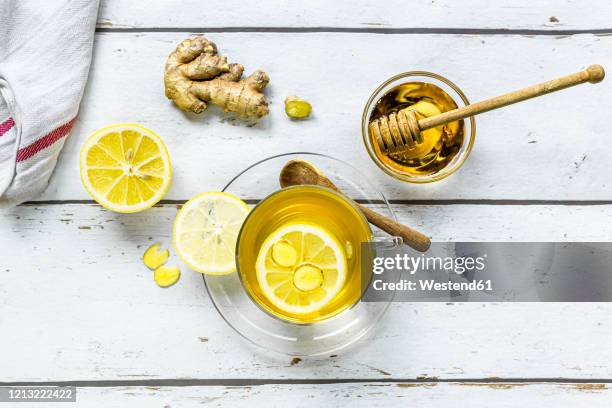 studio shot of hot tea with ginger, lemon and honey - ginger above nobody stock pictures, royalty-free photos & images