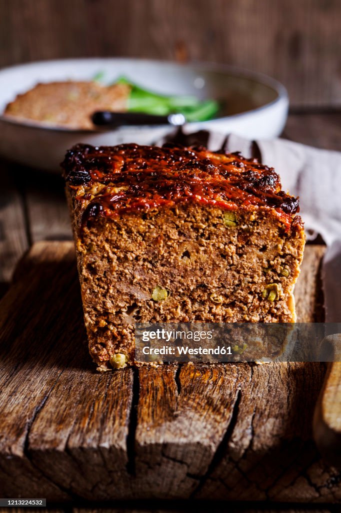 Homemade meat loaf with peas, Italian herbs, dried tomatoes and ketchup glazing