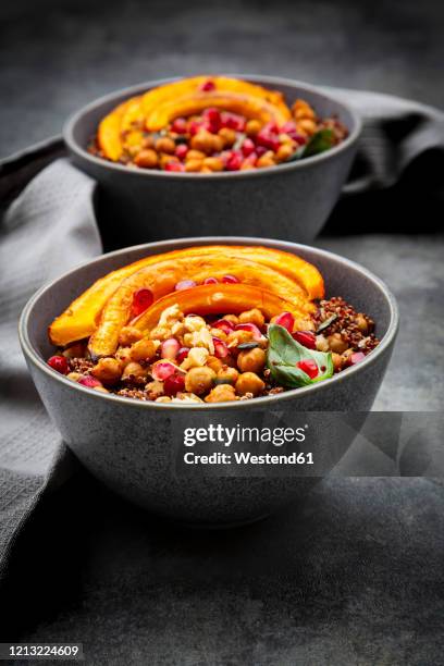 red quinoa with baked pumpkin, chickpeas, pomegranate, basil, walnuts and pumpkin seeds - quinoa and chickpeas stock pictures, royalty-free photos & images