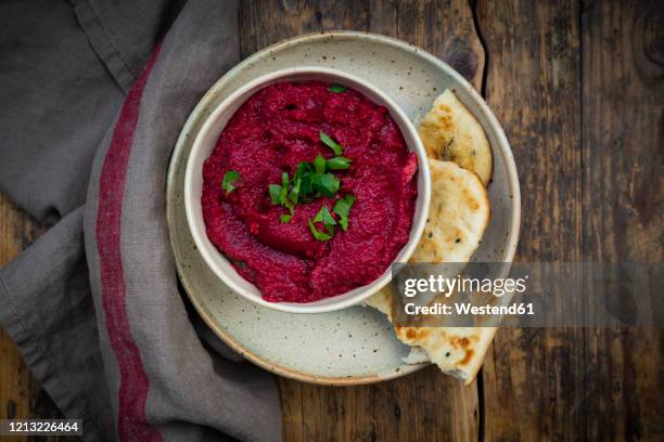 bowl of vegan beetroot hummus with pita bread - stampen stockfoto's en -beelden