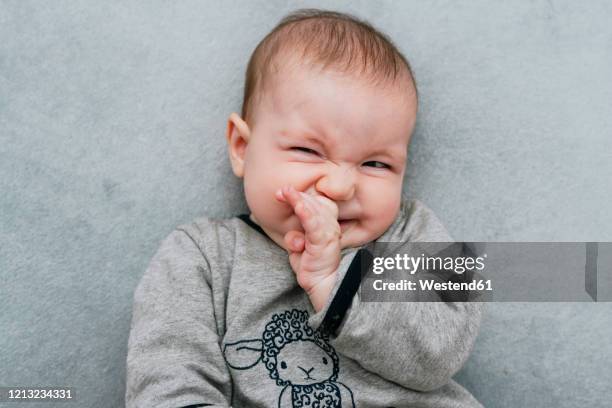portrait of baby girl pulling funny faces - funny face baby stock pictures, royalty-free photos & images