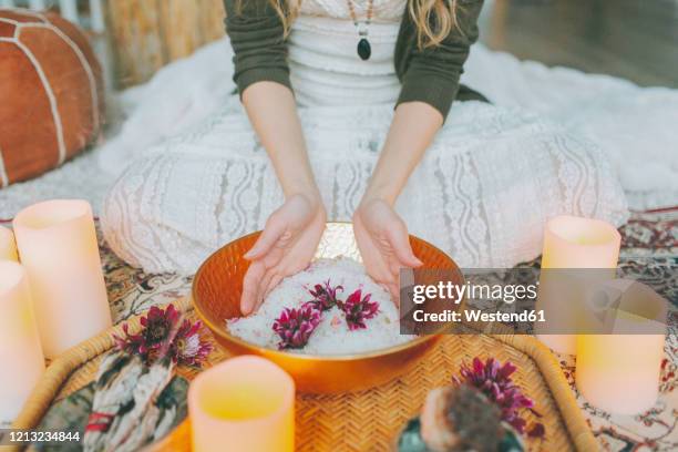 hands in a salt bowl ceremony at a women's circle - ceremony stockfoto's en -beelden