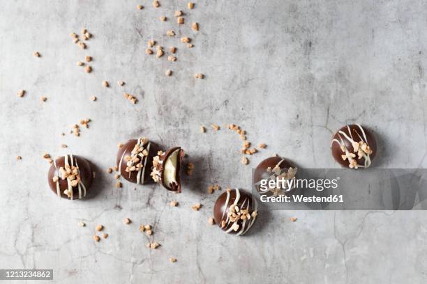 chocolate pralines with hazelnut brittle - praline stock pictures, royalty-free photos & images