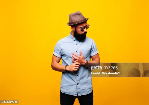 portrait of a stylish young man in studio wearing sunglasses - arrogant man stock pictures, royalty-free photos & images