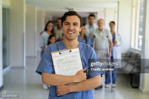 female doctor smiling at the hospital - resident stock pictures, royalty-free photos & images