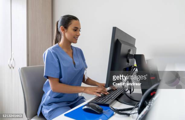 receptionist working at a hospital - secretary pics stock pictures, royalty-free photos & images