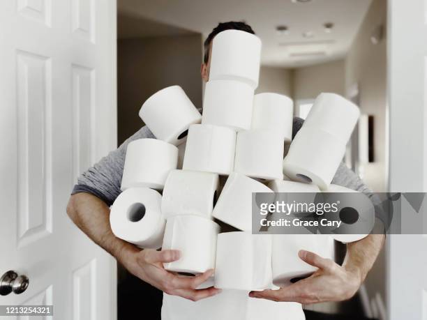 man carries heap of toilet paper - überfluss stock-fotos und bilder