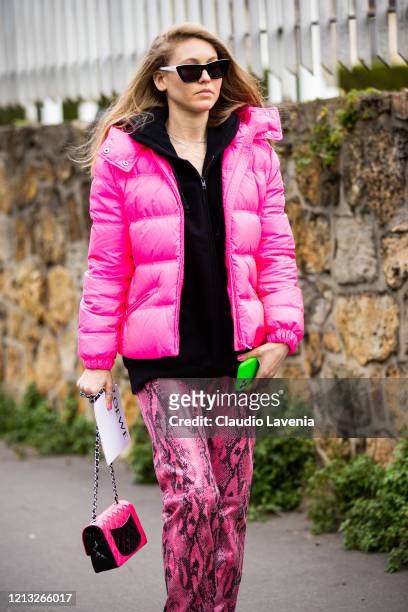 Jessica Minkoff, wearing a black sweatshirt, pink snakeskin print leather pants, fuchsia puffed jacket and pink bag, is seen outside Loewe, during...