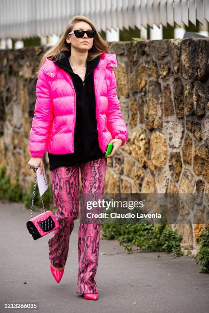 Jessica Minkoff, wearing a black sweatshirt, pink snakeskin print leather pants, fuchsia puffed jacket and pink bag, is seen outside Loewe, during...