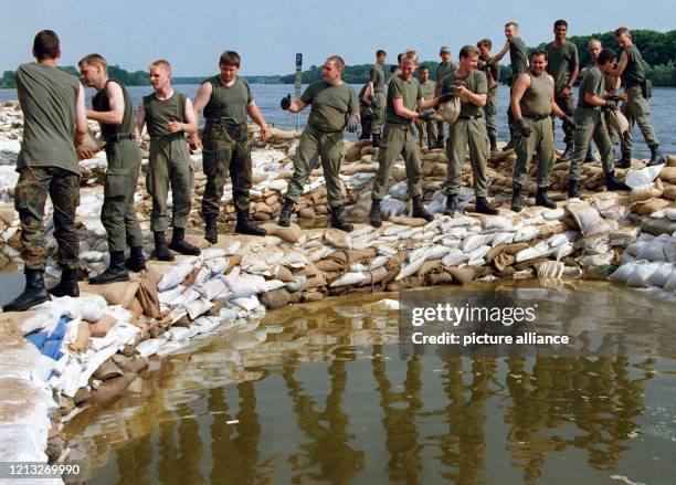 Pausenlos stapeln Bundeswehrsoldaten am 27.7.1997 in Frankfurt Sandsäcke, um den künstlichen Deich an der Oder zu erhöhen. Die Hilfskräfte von...