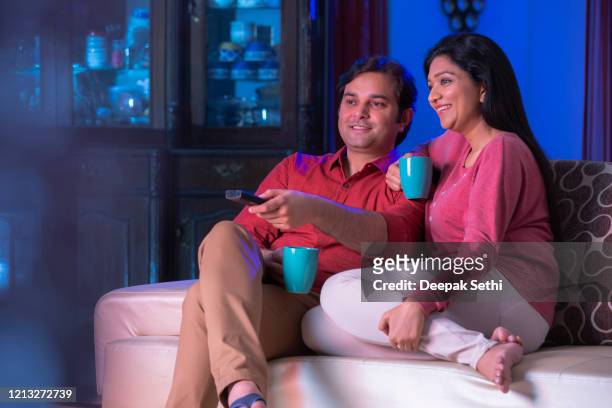 our favorite tv show is just about to start stock photo - indian wife stock pictures, royalty-free photos & images