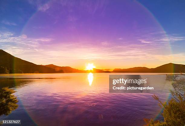 sunrise over bay - sundog stock pictures, royalty-free photos & images