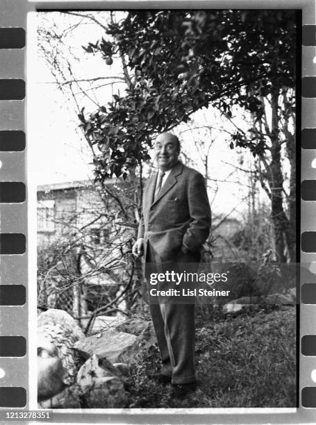 Chilean poet and politician Pablo Neruda stands, one hand in his pocket, outside one of his homes, Chile, 1960s.