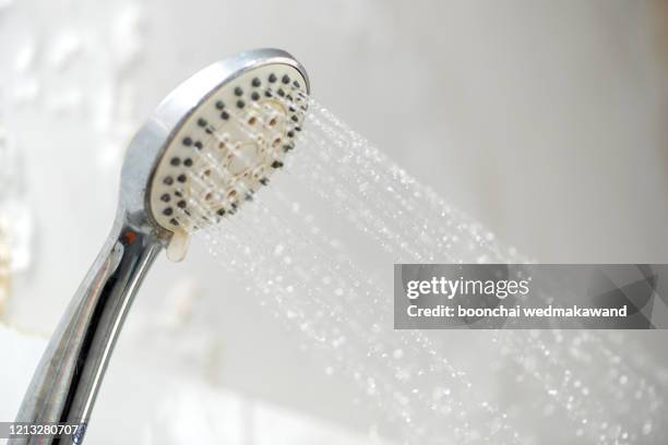 shower head and running water - shower stock pictures, royalty-free photos & images