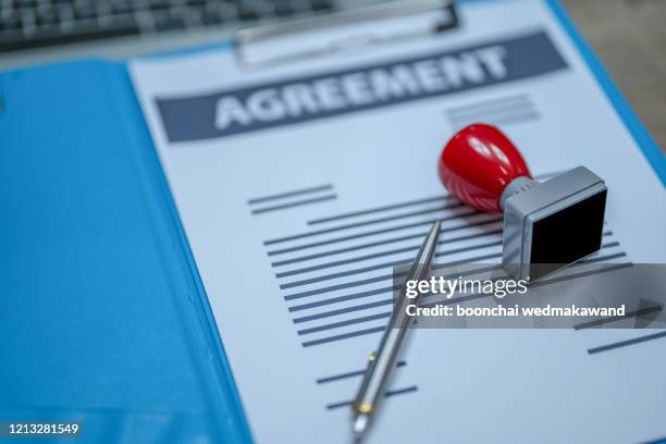 approved stamp on document at desk - contract illustration stock pictures, royalty-free photos & images