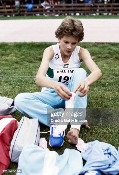 Runner Zola Budd puts her socks on after a race in the United Kingdom circa 1985 .