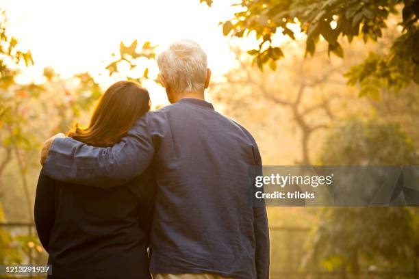 couple relaxing at park - old silhouette man stock pictures, royalty-free photos & images