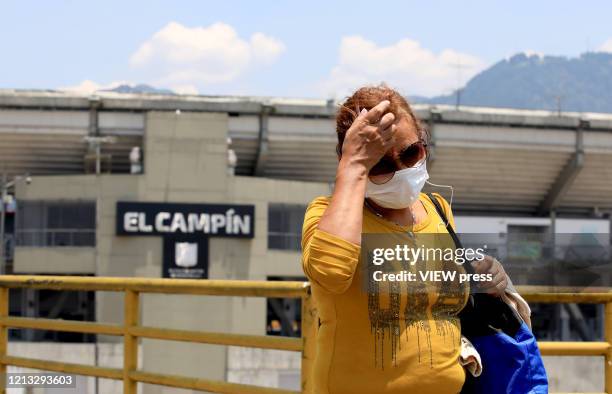 Woman wearing a protective mask walks near El Campin Stadium on March 17, 2020 in Bogota, Colombia. CONMEBOL announced today that Copa America...