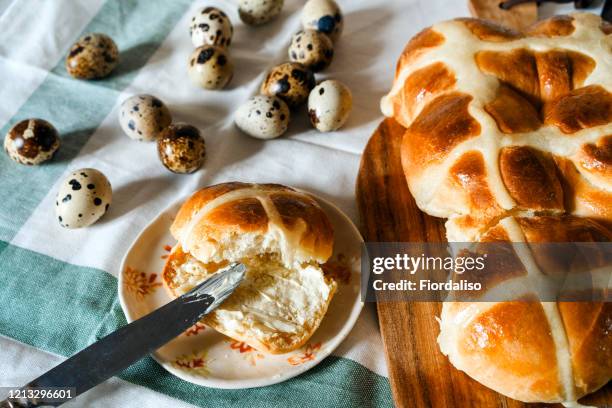 easter homemade hot cross buns, buttered with butter, quail unpainted eggs - easter dinner stock pictures, royalty-free photos & images