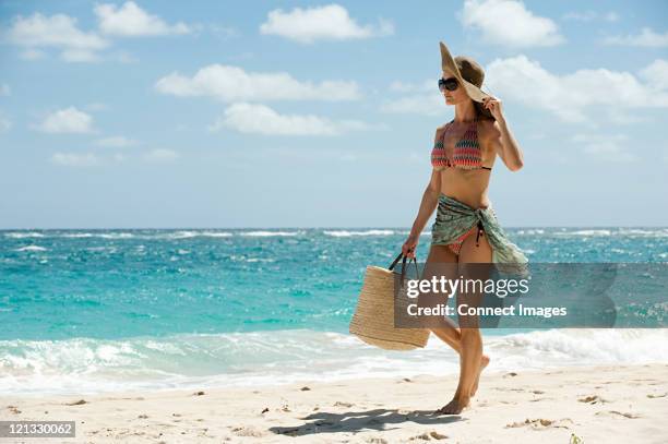 woman walking on sandy beach, mustique, grenadine islands - sarongs for women stock pictures, royalty-free photos & images