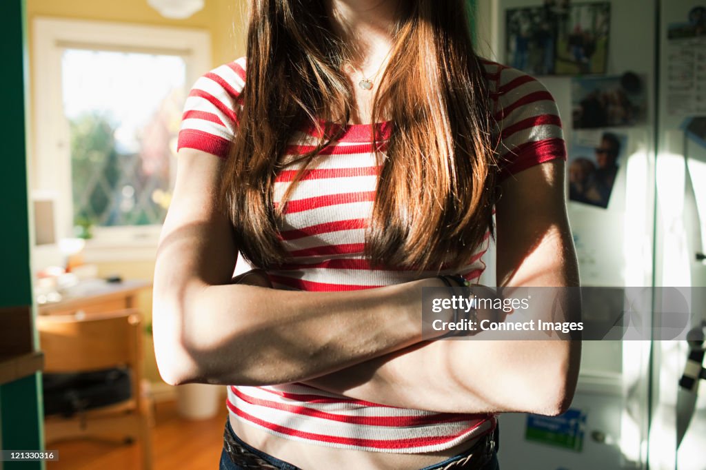 Teenage girl with arms crossed