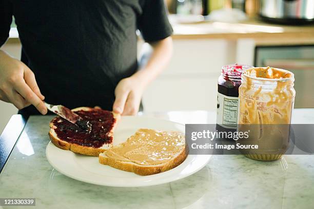 boy making sandwich - peanut butter and jelly sandwich fotografías e imágenes de stock