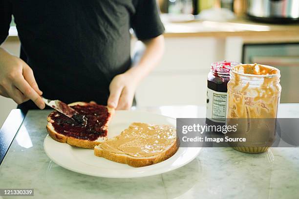 boy making sandwich - peanut butter and jelly sandwich stock pictures, royalty-free photos & images
