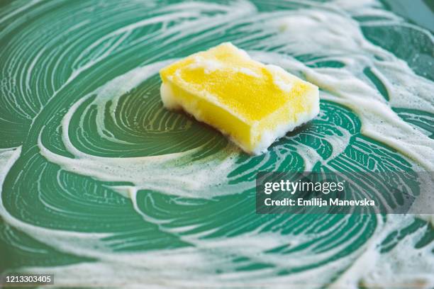 cleaning with yellow sponge - dirty dish stock-fotos und bilder