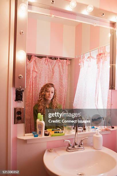 sad teenage girl reflected in bathroom mirror - body image stock pictures, royalty-free photos & images