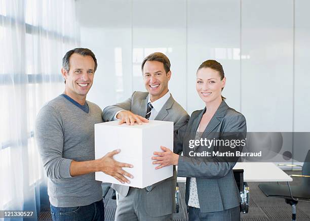 business people holding large white cube - one in three people stock pictures, royalty-free photos & images
