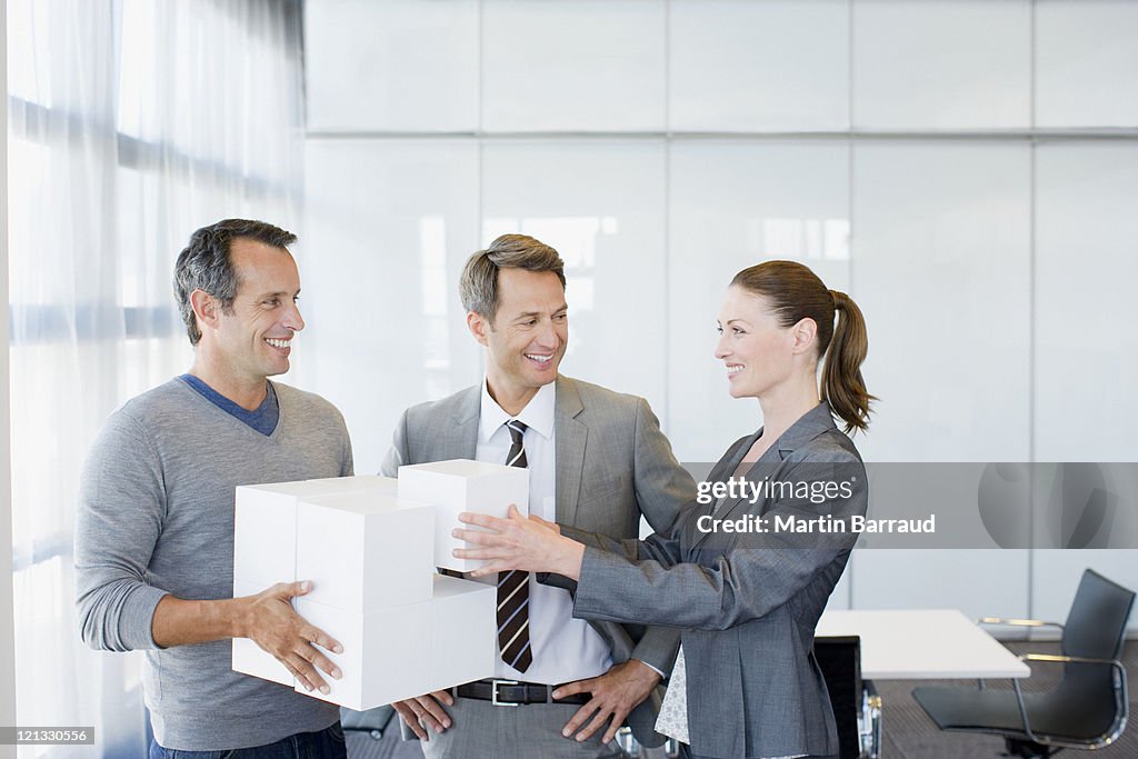 Business people stacking cubes in conference room