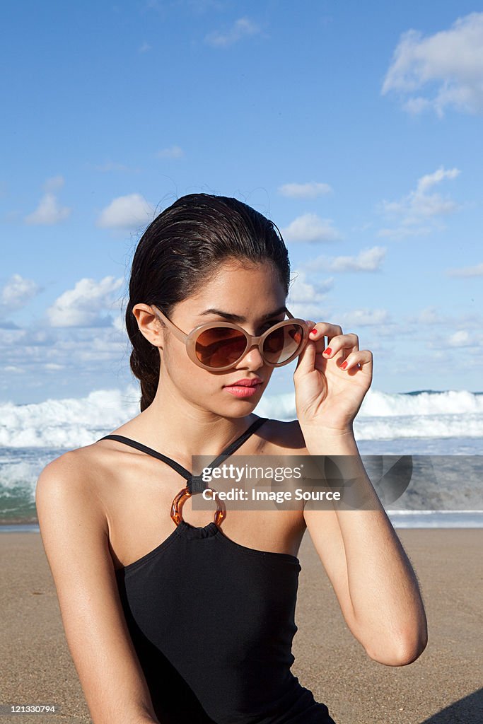 Woman on beach wearing sunglasses