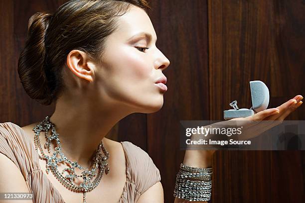 young woman looking at engagement ring in box - woman diamond necklace stock pictures, royalty-free photos & images
